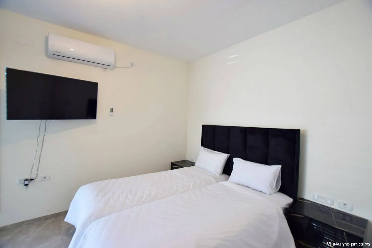 Kinneret House – bedroom with two beds and TV