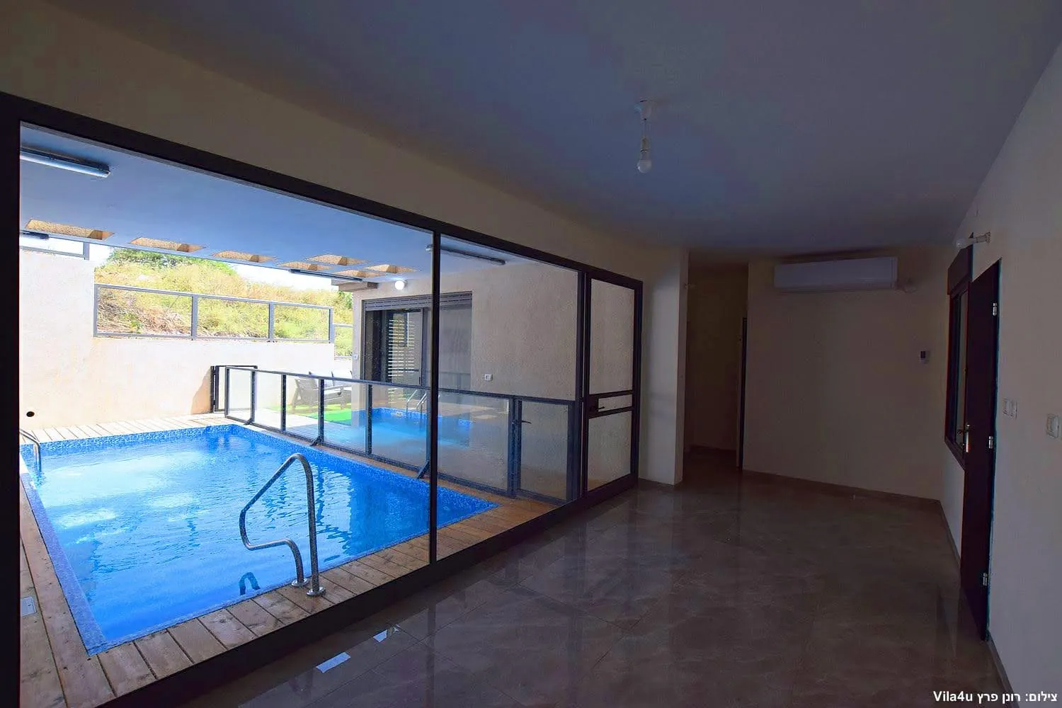 Kinneret House – the pool seen through the glass doors